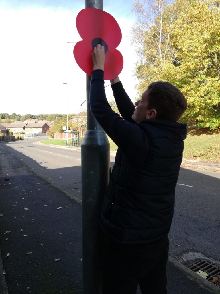 Putting up poppies on lamp-posts